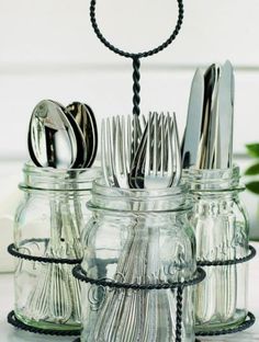 there are many silverware in the glass jars