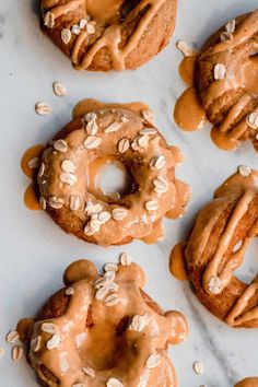 several doughnuts covered in peanut butter and drizzled with icing