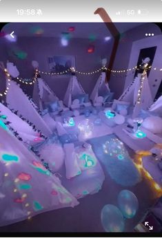 a room filled with lots of white snow covered in lights and decorations on the walls