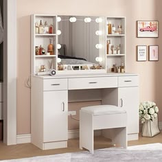 a white vanity with lights on it and a stool in front of the mirror that is open