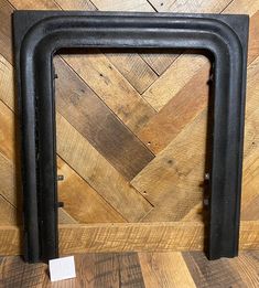 a black frame sitting on top of a wooden floor