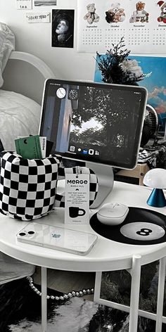 a laptop computer sitting on top of a white table