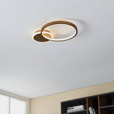 an overhead view of a ceiling light in a room with bookshelves and cabinets