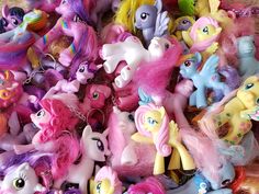 a pile of little pony toys sitting next to each other