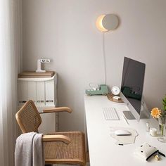 a white desk with a chair and computer on it