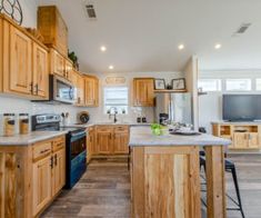 a kitchen with wooden cabinets and an island