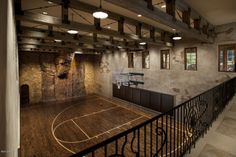 an image of a basketball court in the middle of a room with stairs and railings