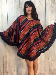 Love This Vintage Poncho!Vibrant Gorgeous Colors and PatternFolk ArtHandmadeHandwovenHand EmbroideredFeels like CottonExcellent Condition!One Size Fits Most!Length~30" Bohemian Handwoven One-size Cape, Bohemian One-size Handwoven Cape, Traditional Fringe Poncho One Size, Red Bohemian Poncho With Fringe, Red Bohemian Poncho For Festival, Bohemian Red Shawl Cape, Bohemian Handwoven Poncho For Winter, Handwoven Poncho Shawl For Festivals, Bohemian Handwoven Shawl Poncho