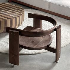 a wooden chair sitting on top of a white rug