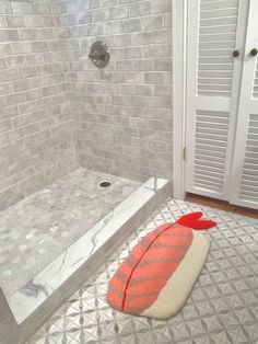 a bathroom with a shower, toilet and rug