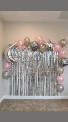 a room filled with balloons and stars on the wall