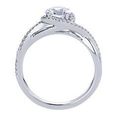 a white gold engagement ring with an oval diamond center and side stones on the band