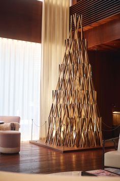 a large wooden christmas tree sitting on top of a hard wood floor