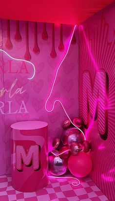 a pink room with neon lights and decorations