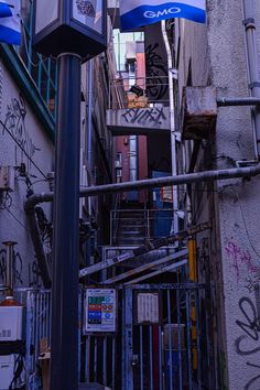 an alleyway with graffiti on the walls and street signs