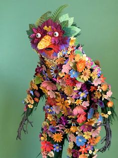 a bird made out of flowers and leaves