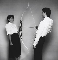 a man and woman standing next to each other with the words me bad luck written on them