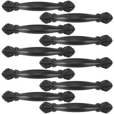 six black handles with ornate designs on each one side and the other end, all facing different directions