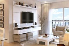 a living room filled with furniture and a flat screen tv on top of a wall