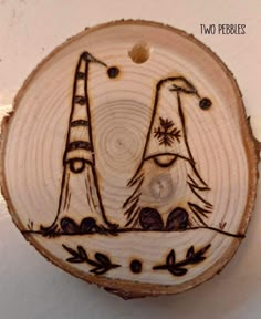 a piece of wood that has been carved into the shape of two lighthouses on it