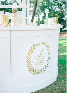 an outdoor bar decorated with gold and white decorations