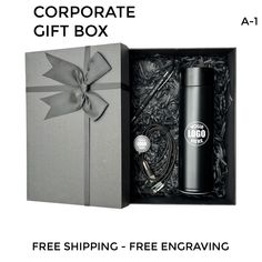 the corporate gift box is open and has a bottle in it with a ribbon around it