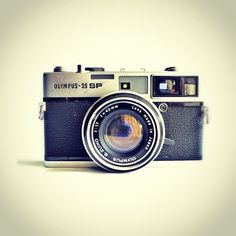 an old fashioned camera with a lens attached to it's body and the words olympus sp written on the front