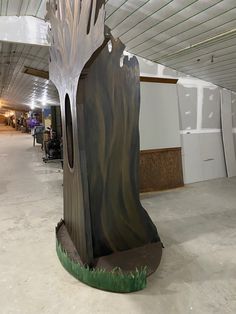 a large piece of art that looks like a tree stump in the middle of a building