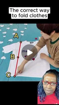 two children are making clothes with paper and glue on the floor, one child is wearing glasses