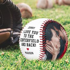 a baseball sitting on top of a lush green field