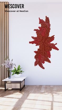 a large piece of bacon hanging on the wall next to a vase with flowers in it