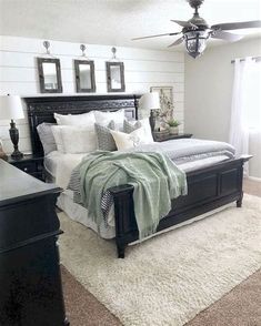 a bedroom with white walls and black furniture