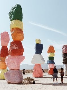 several large rocks stacked on top of each other in the middle of a desert area