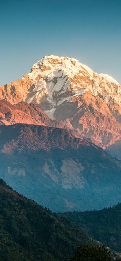 the mountain is covered in snow and brown