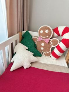 a crib with christmas decorations on it and a gingerbread man in the bed