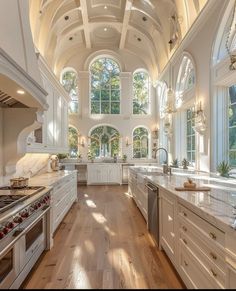 a large kitchen with an arched ceiling and white cabinets