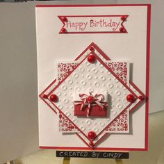 a handmade birthday card with a red bow