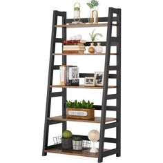 a ladder shelf with books and plants on it