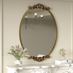 a white mantle with a mirror and flowers on it in front of a fireplace mantel