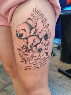 a woman's thigh with flowers on it and a quote from winnie the pooh