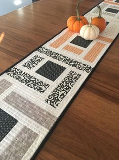 a table runner with two pumpkins on it