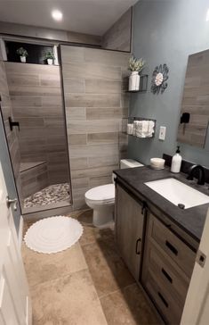 a bathroom with two sinks, a toilet and a walk - in shower next to each other