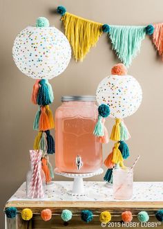 a table topped with pink liquid and tassels