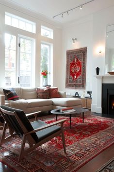 a living room filled with furniture and a fire place in front of a large window