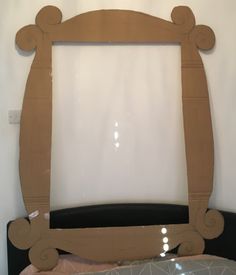 a bed frame made out of cardboard with an oval design on the bottom and sides