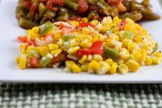 a white plate topped with corn and vegetables