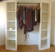 an organized closet with clothes hanging on shelves