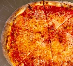 a cheese pizza sitting on top of a metal pan