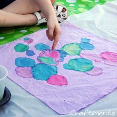 a child is painting on a piece of paper