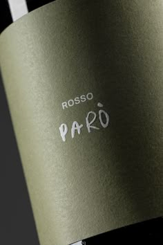 a bottle of red wine with the word paso written in white on it's side